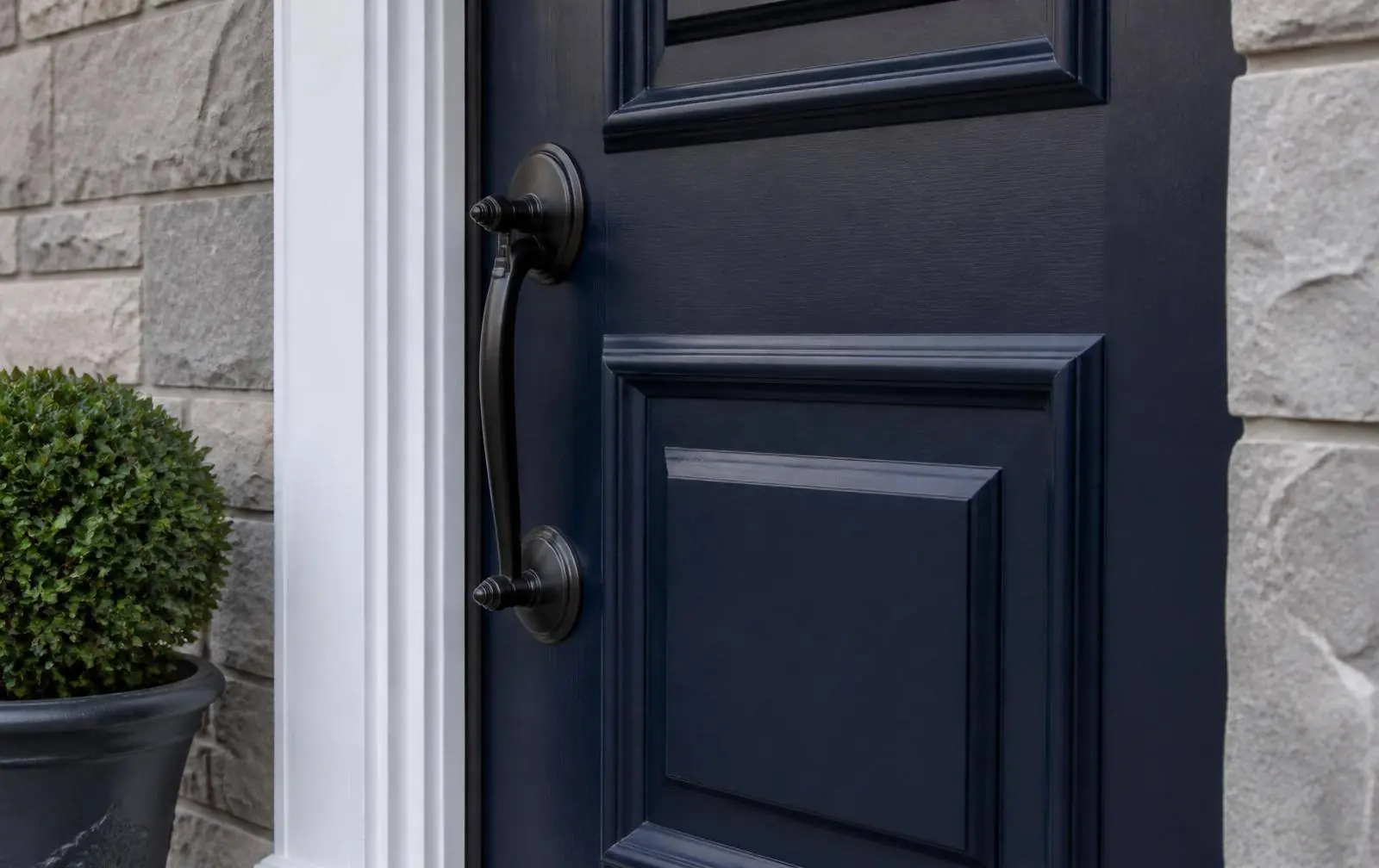 Freshly painted navy front door with clean white trim